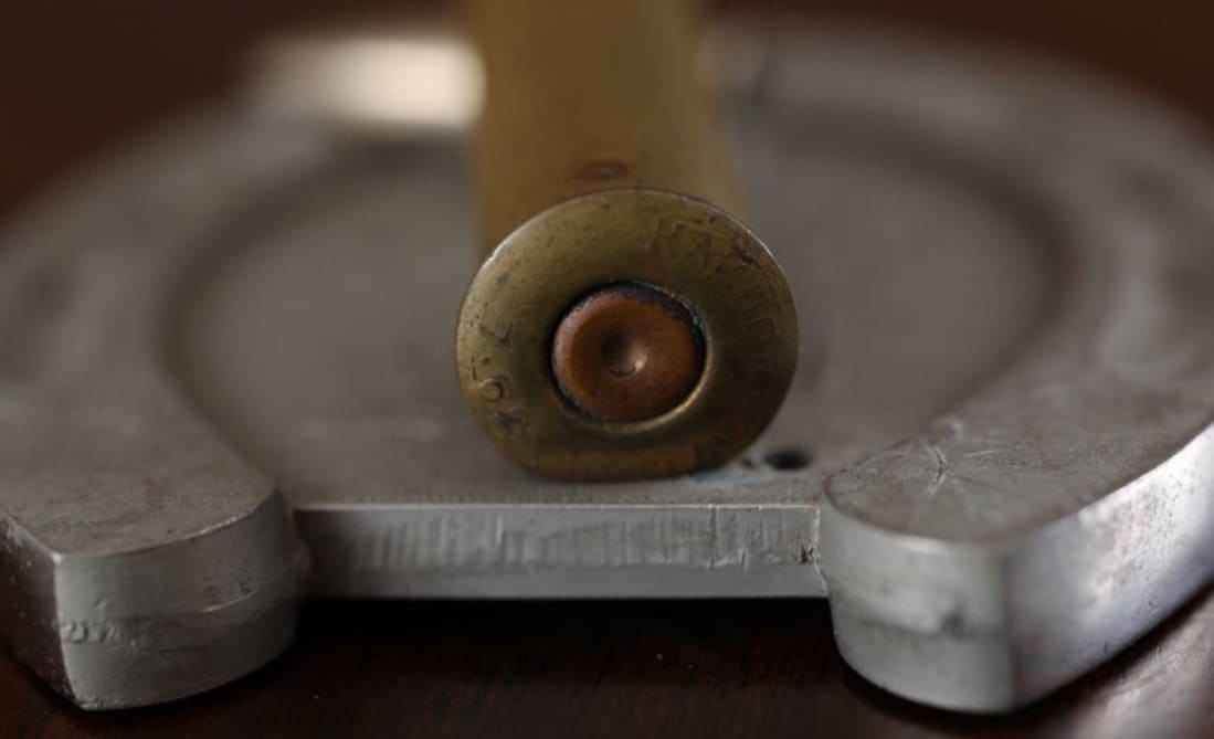 Bullet Case  on a Horseshoe Commemorative Paperweight.jpg