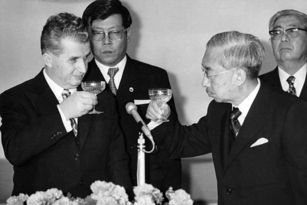 Romanian President Nicolae Ceausescu and Emperor Hirohito toast glasses during their luncheon at the Imperial Palace on April 4, 1975 in Tokyo, Japan..jpg