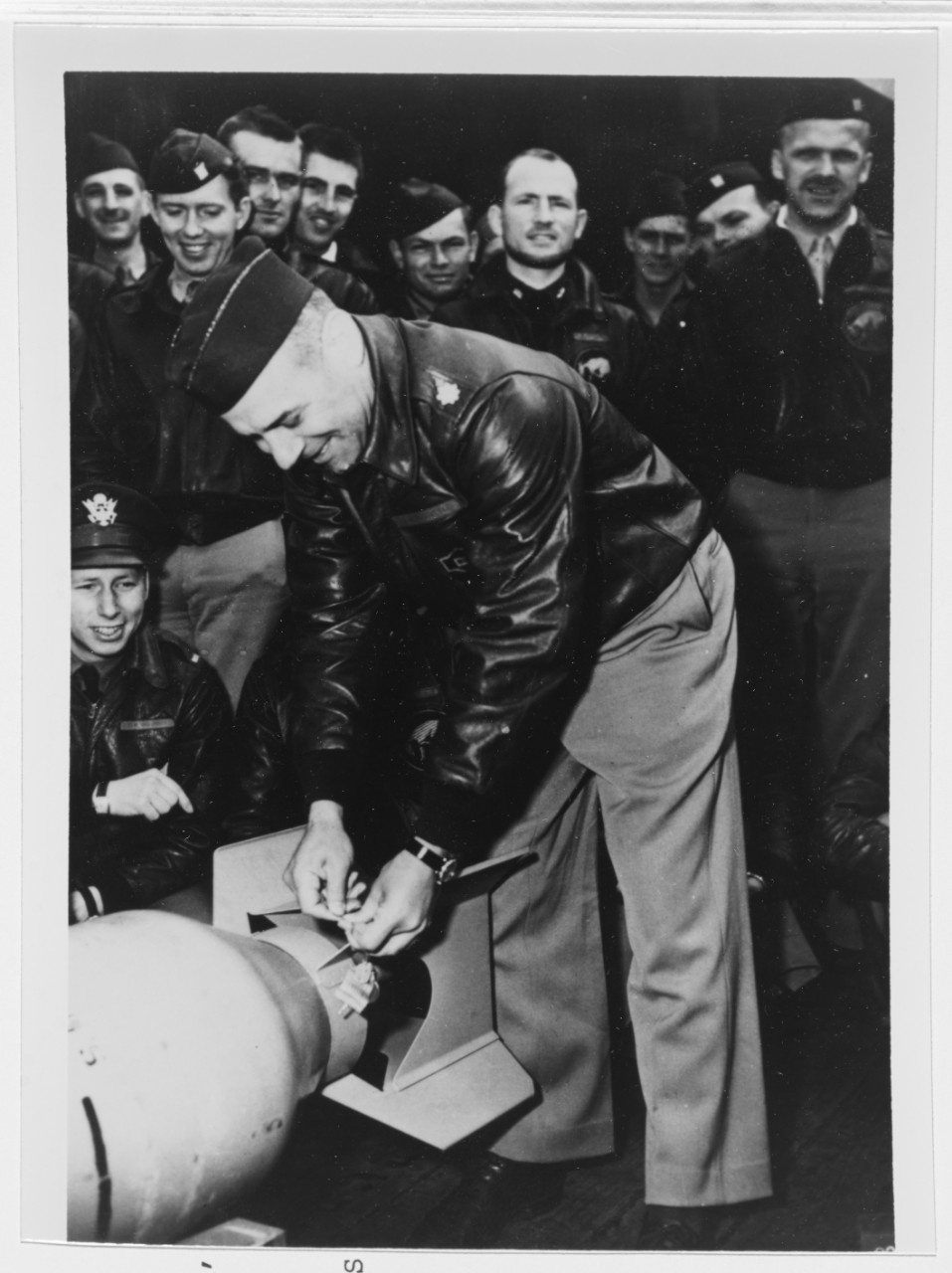 wires a Japanese medal to a 500-pound (227-kilogram) bomb.jpg